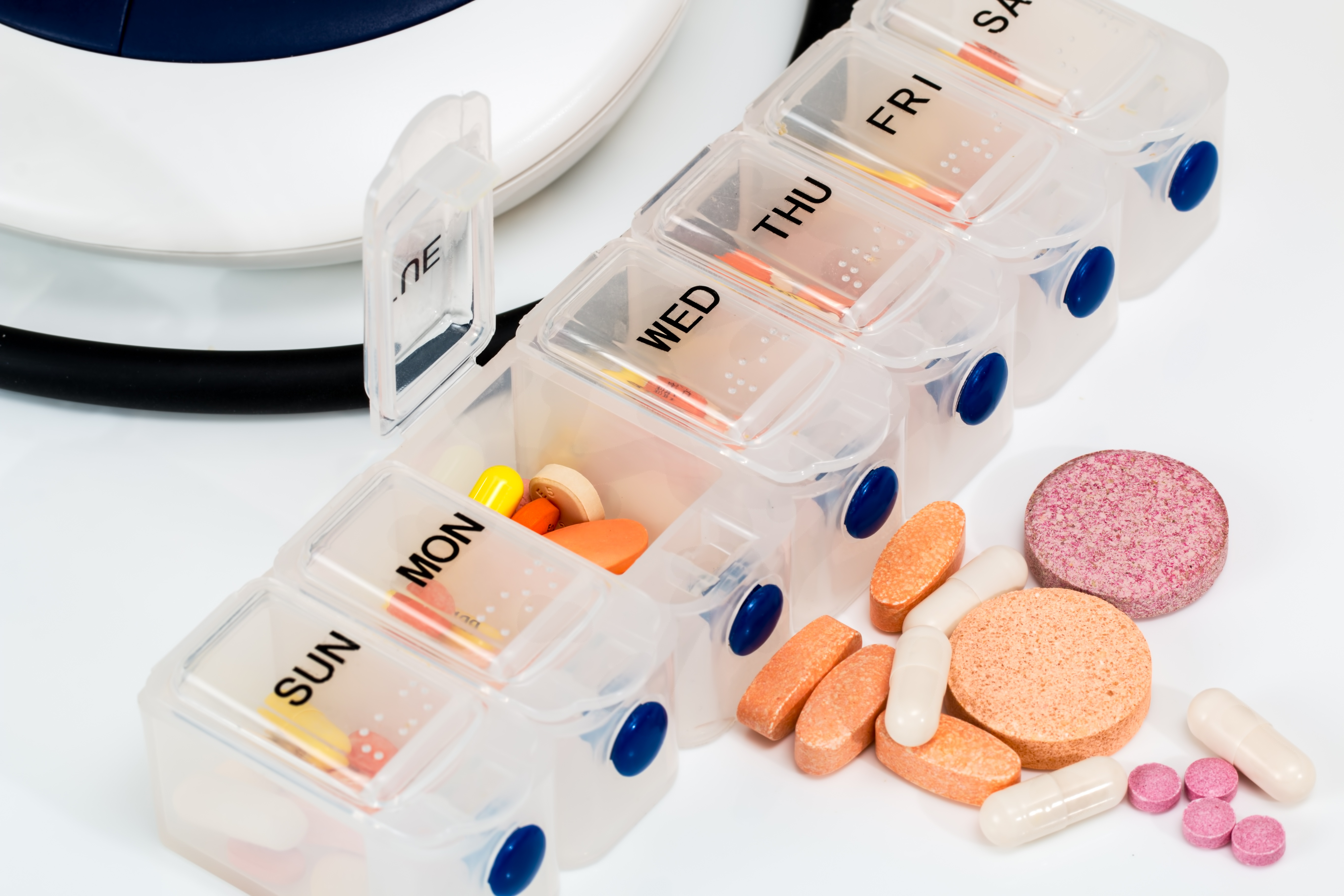 Weekly pill organizer filled with medications