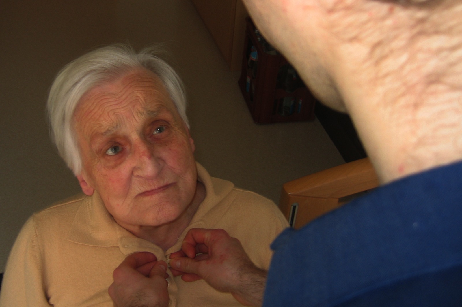 Older adult being assisted by a caregiver